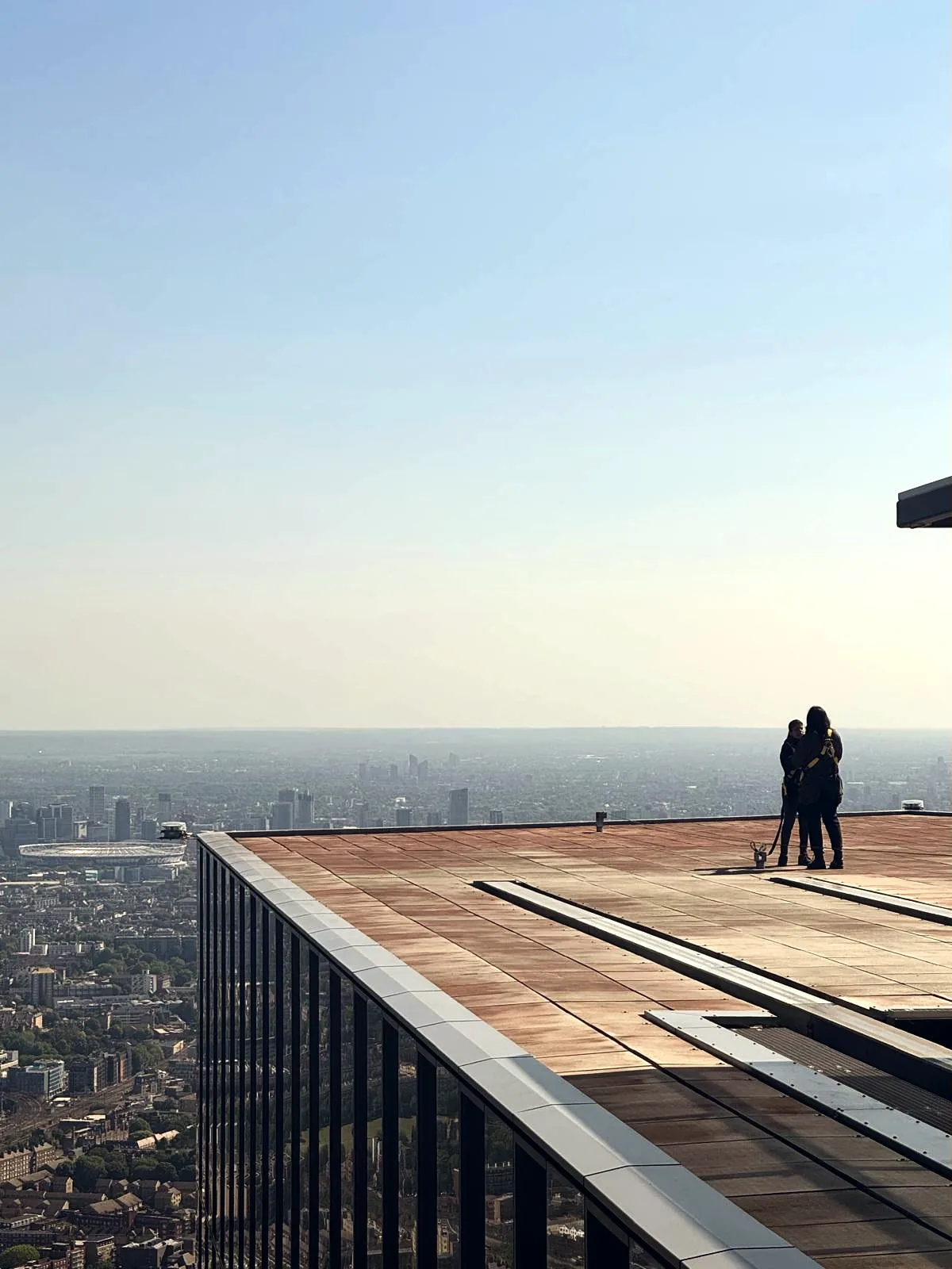 Two figures on a high terrace looking out across London