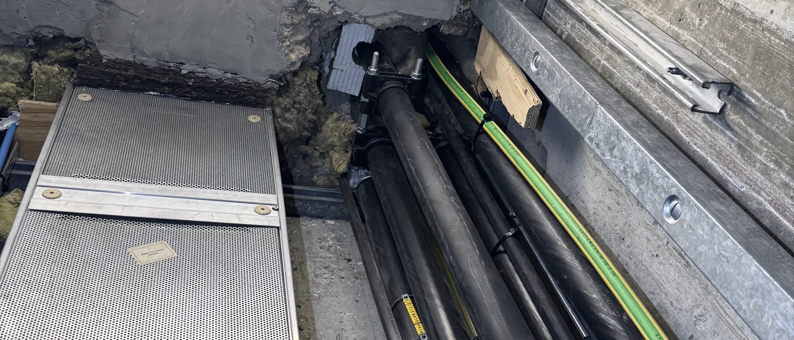 A cable run passing through a compartment wall with fire-stopping seals